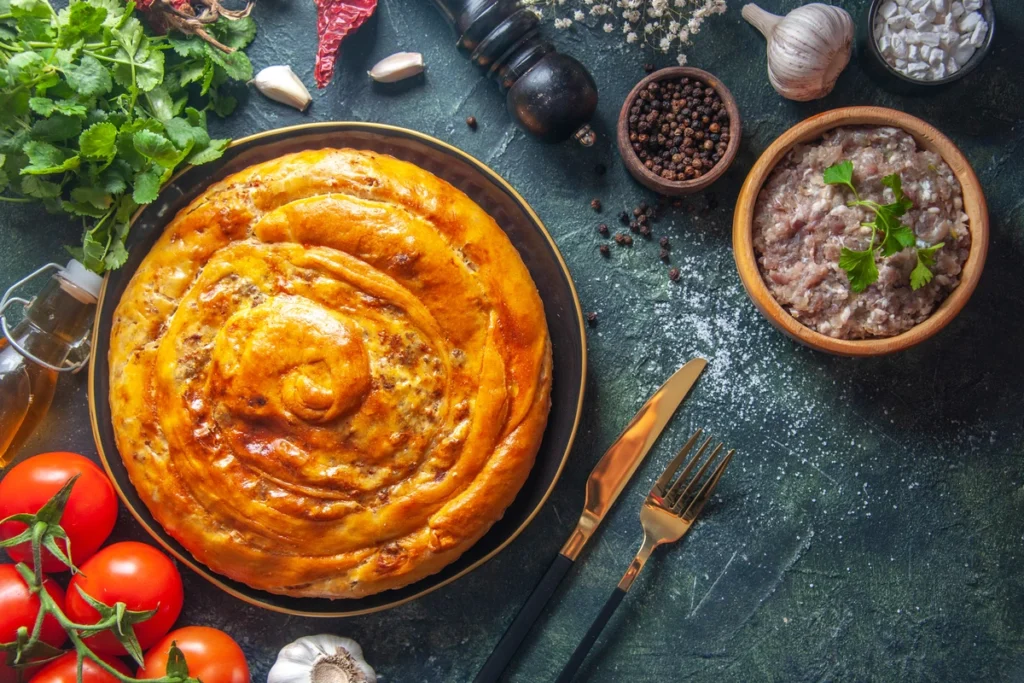 Golden, flaky Passover Potato Pie with a crisp crust and a soft, savory potato filling, garnished with fresh herbs.