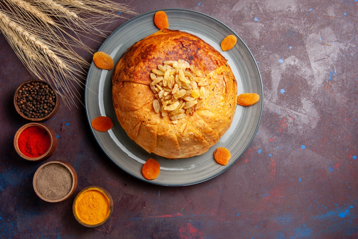 A golden-brown Passover potato pie served on a white plate, garnished with fresh herbs for added flavor