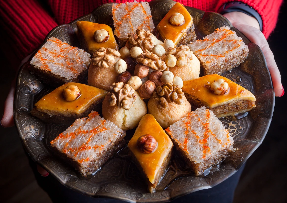 Arabic sweets beautifully presented on a festive table, ready for a celebration.