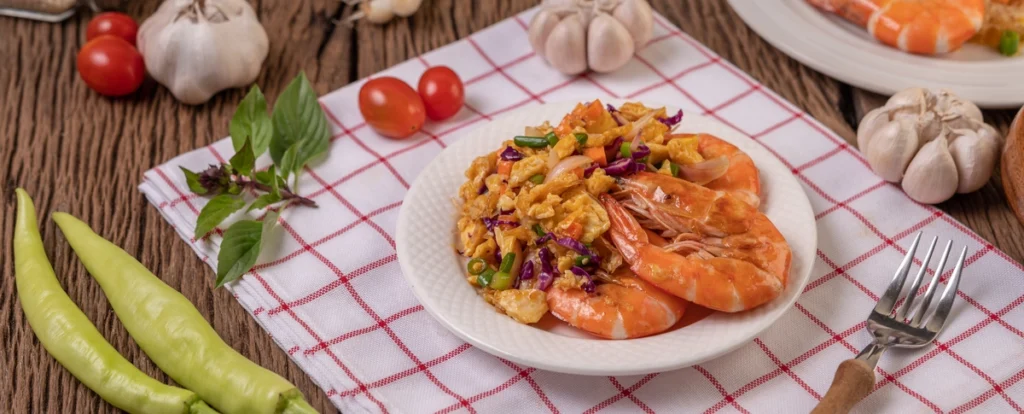 A delicious plate of garlic shrimp, sautéed to perfection with garlic, butter, and seasonings, served as a flavorful and savory dish.