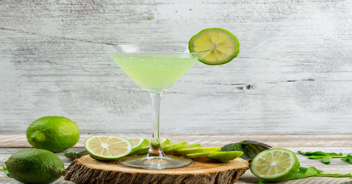 A refreshing margarita in a salt-rimmed glass garnished with a lime wedge.