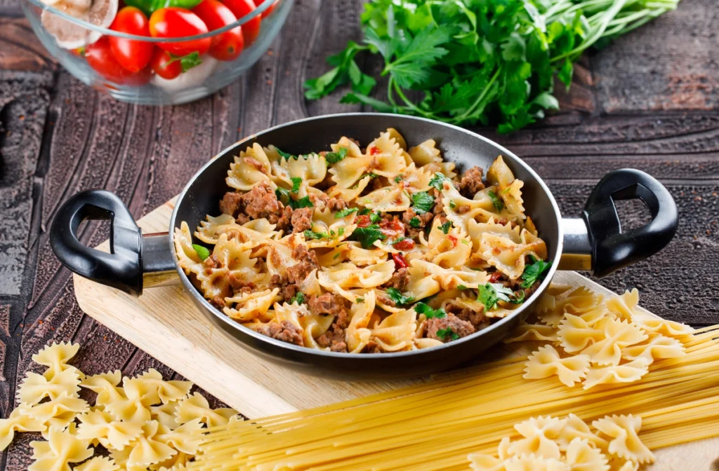 A plate of Barilla Protein Pasta topped with cheese, roasted vegetables, and fresh herbs.