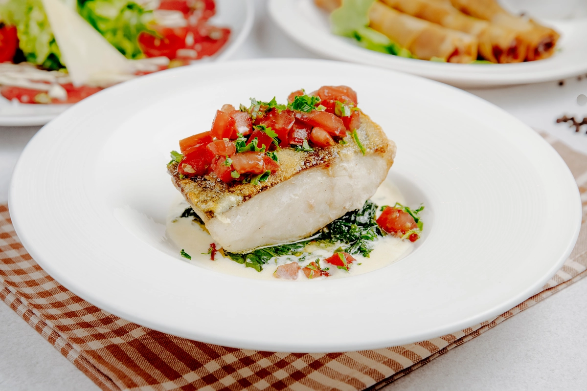 Quick and healthy fish food recipe featuring pan-seared salmon with a side of quinoa and steamed vegetables.